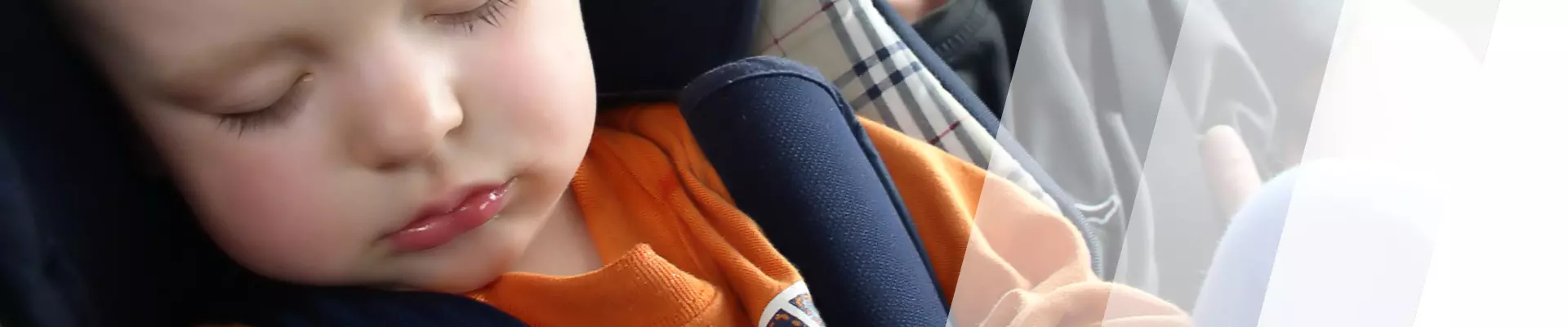 Ein Baby schläft im Kindersitz